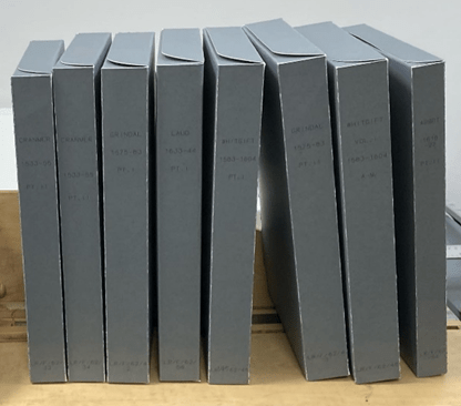 Eight grey archival upright book boxes