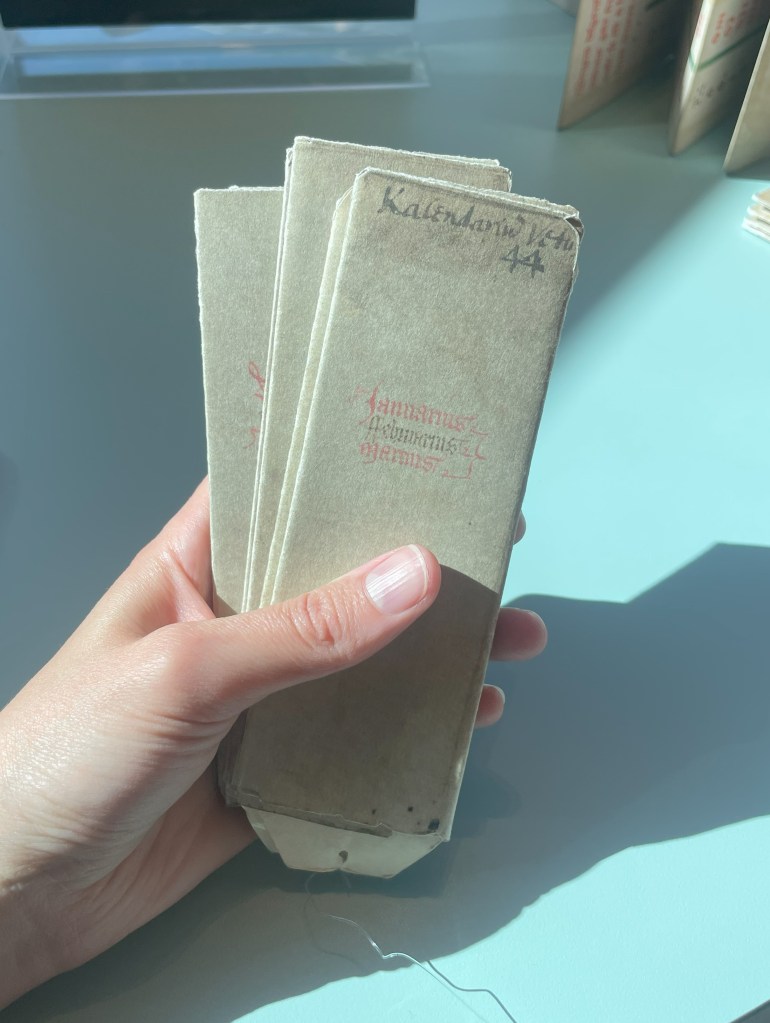 Folded bat book facsimile being held up